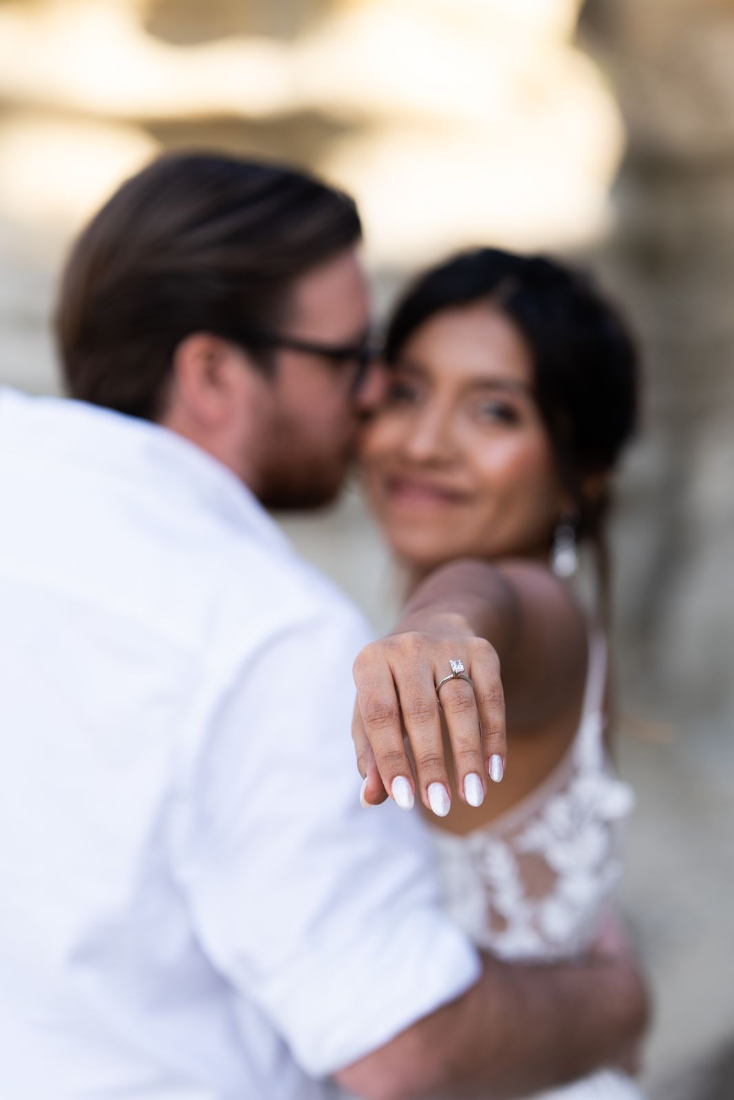 Bride holding out her hand to show her engagement ring