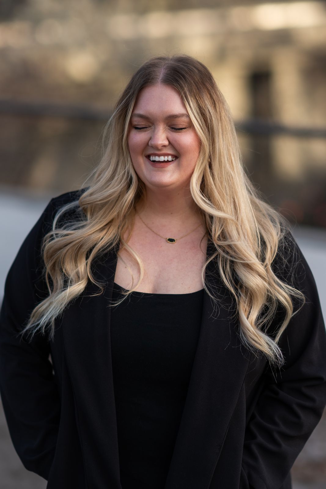 Senior portrait of a smiling young woman in black