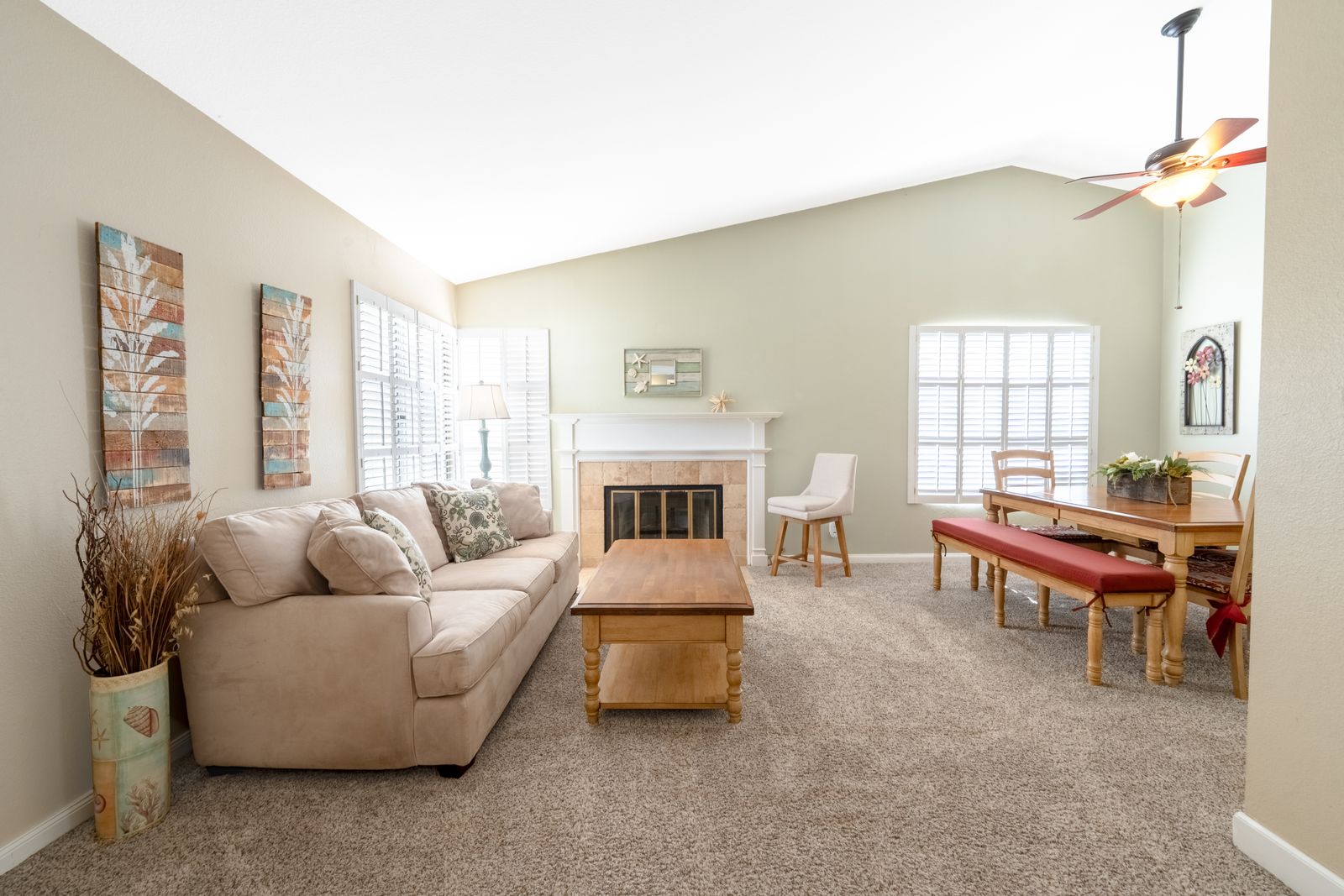 Living room with a fireplace, sofa and dining table